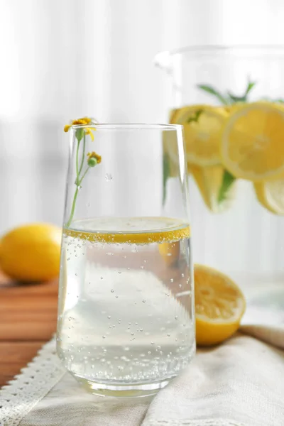 Jug and glass with refreshing lemon water — Stock Photo, Image