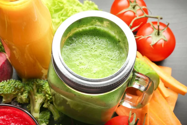 Fresh smoothies and vegetables on table — Stock Photo, Image