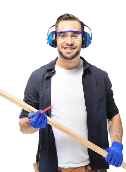 Smiling carpenter holding wooden plank — Stock Photo, Image