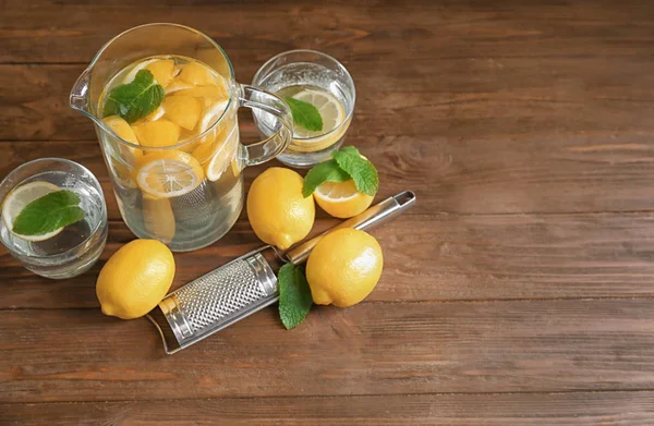 Caraffa e bicchieri con acqua di limone rinfrescante — Foto Stock