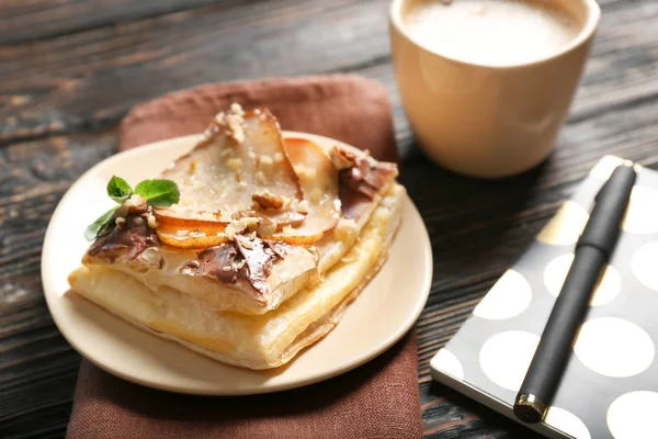 Piatto con deliziosa pasticceria, cancelleria e tazza di caffè — Foto Stock