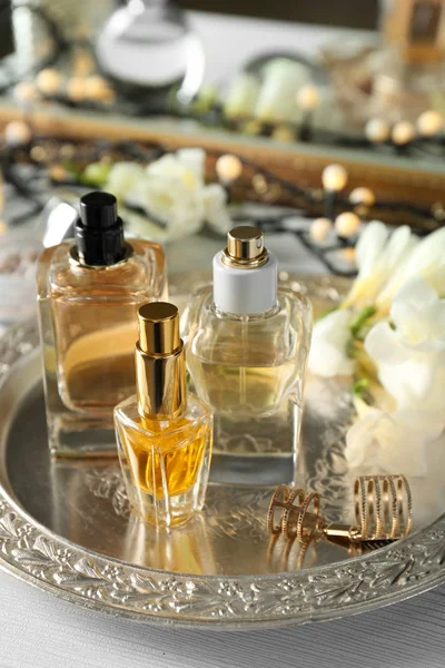 Golden tray with perfume bottles — Stock Photo, Image