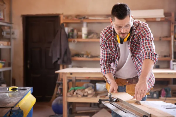 Carpenter sawing timber — Stock Photo, Image