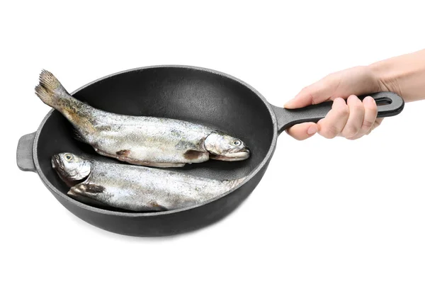 Hand holding frying pan with fish — Stock Photo, Image