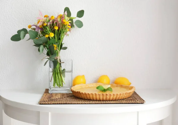 Composition with lemon tart and flowers
