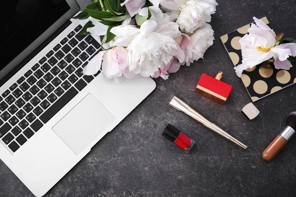 peony flowers, laptop and cosmetics