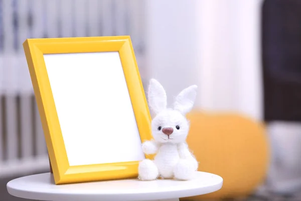 Empty photo frame with toy — Stock Photo, Image