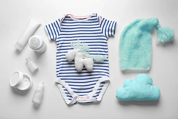 Bodysuit and baby care accessories — Stock Photo, Image