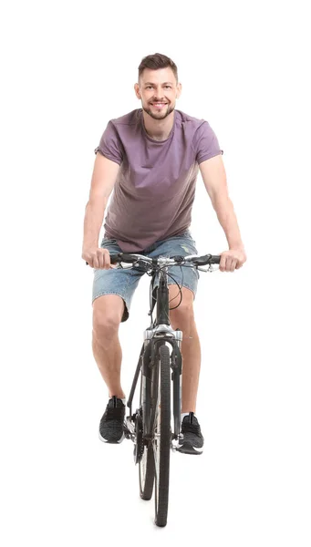 Bonito jovem andando de bicicleta no fundo branco — Fotografia de Stock