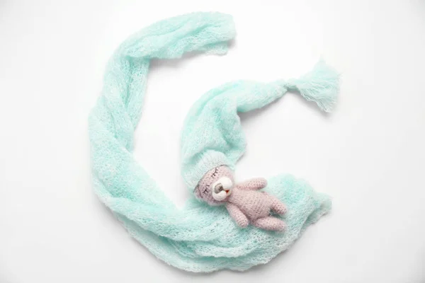 Knitted toy with baby clothes — Stock Photo, Image