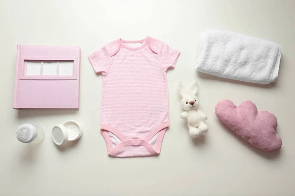 Bodysuit  and baby care accessories — Stock Photo, Image