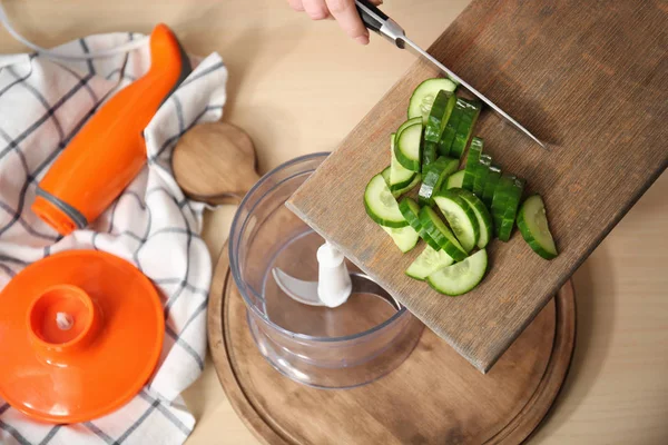 Mulher derramando fatias de pepino — Fotografia de Stock