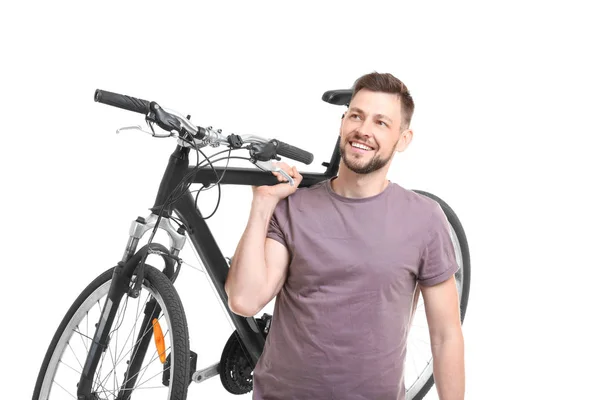 Bonito jovem com bicicleta no fundo branco — Fotografia de Stock