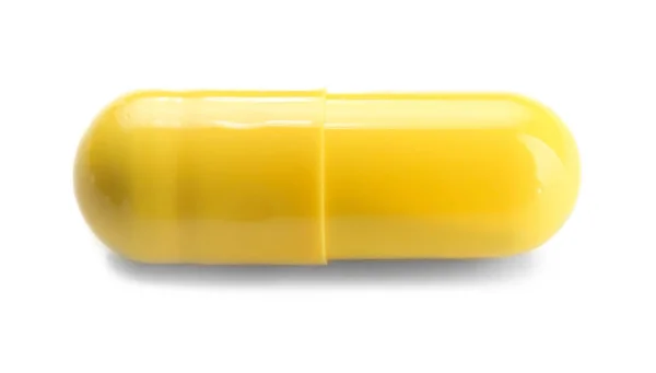 Желтая лекарственная таблетка — стоковое фото