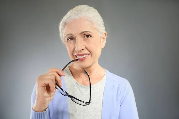 Elegant elderly woman with glasses — Stock Photo, Image