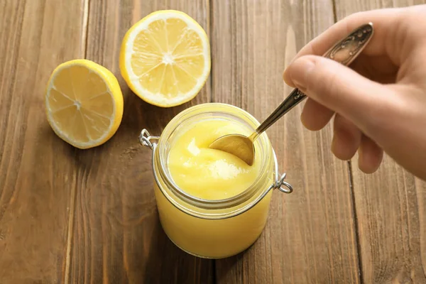 Woman taking lemon curd — Stock Photo, Image