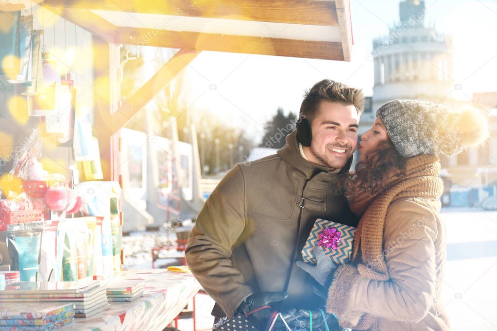Young couple shopping at traditional Christmas fair