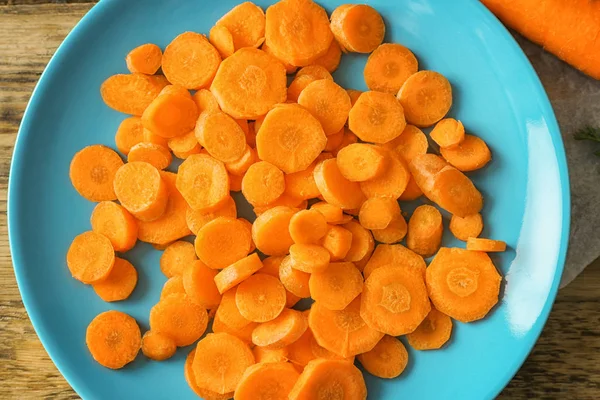 Assiette bleue avec des morceaux de carotte — Photo