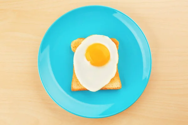 Egg and toast on wooden background — Stock Photo, Image