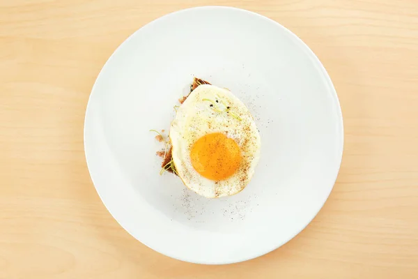 Яйцо и ломтик хлеба на деревянном фоне — стоковое фото