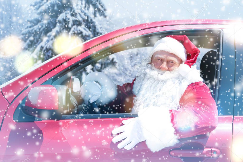 Santa Claus driving car in forest during snowfall, Christmas and New Year celebration