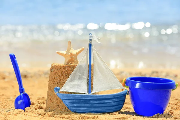 Composition with colorful toys on sea shore — Stock Photo, Image