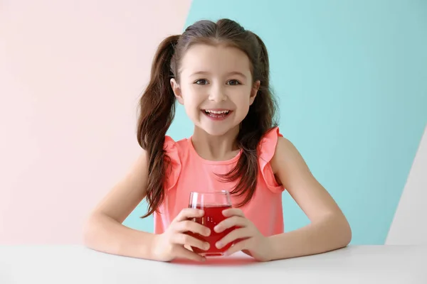 Cute little girl with glass of juice — Stock Photo, Image