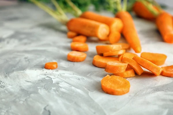 Slices of carrot on grey — Stock Photo, Image