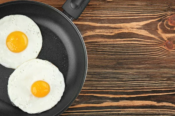 Frying pan with tasty over eggs