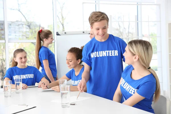 Meeting of young volunteers team in office — Stock Photo, Image