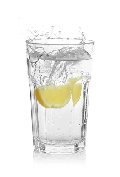 Glass of lemonade with splashing water — Stock Photo, Image