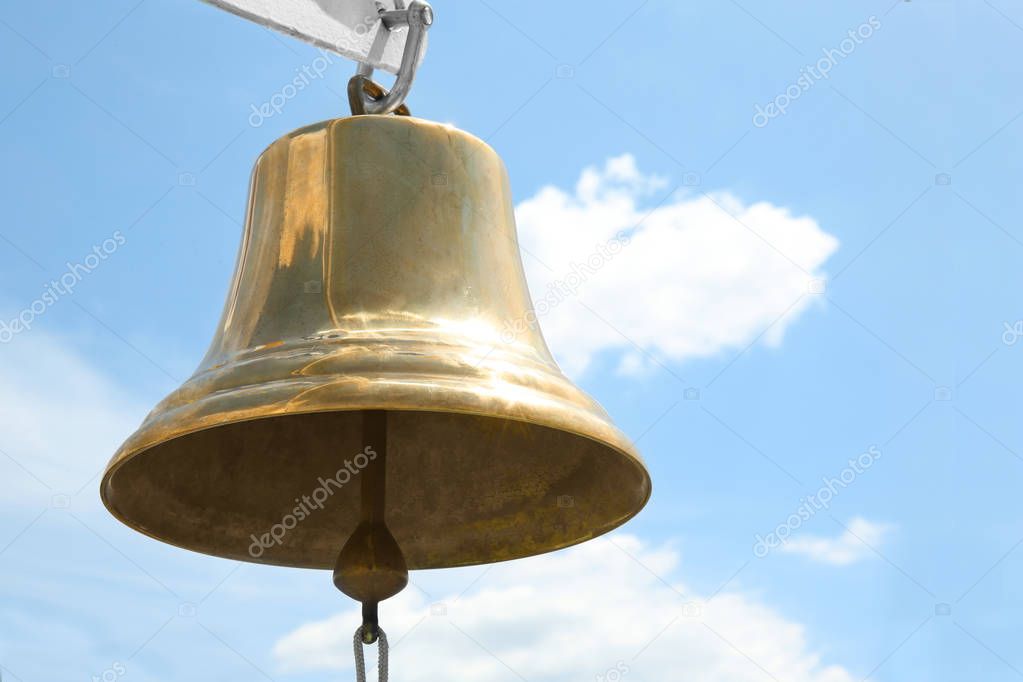 Ship bell against sky