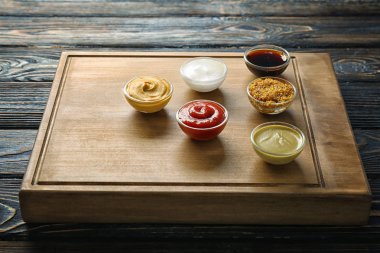 Tahta ahşap arka plan üzerinde farklı sos ile