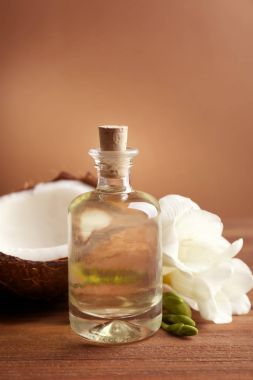 Şişe ahşap masa üzerinde kaplıca tedavisi için Hindistan cevizi yağı ile kompozisyon