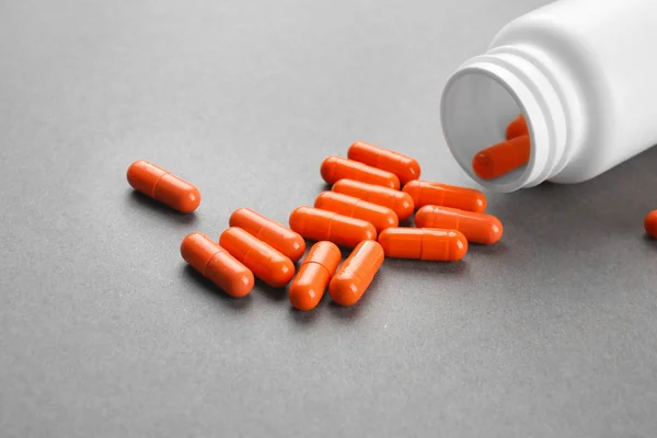 Health care concept. Pills and jar on grey background — Stock Photo, Image