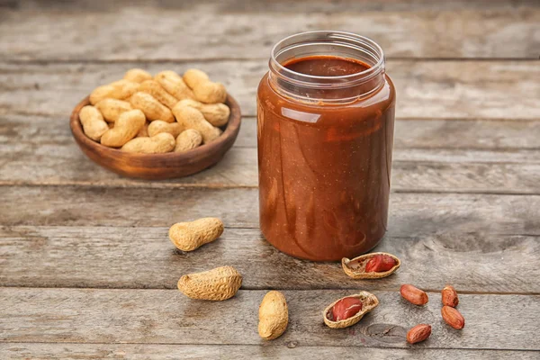 Jar with creamy peanut butter on table — Stock Photo, Image