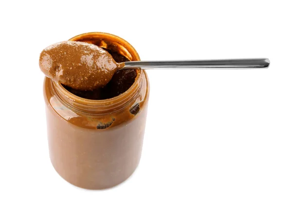 Creamy peanut butter in spoon and jar on white background — Stock Photo, Image