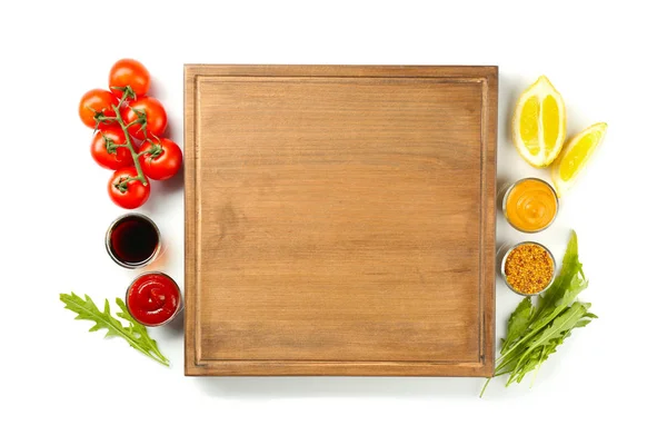 Composition with wooden plate and different sauces on white background — Stock Photo, Image