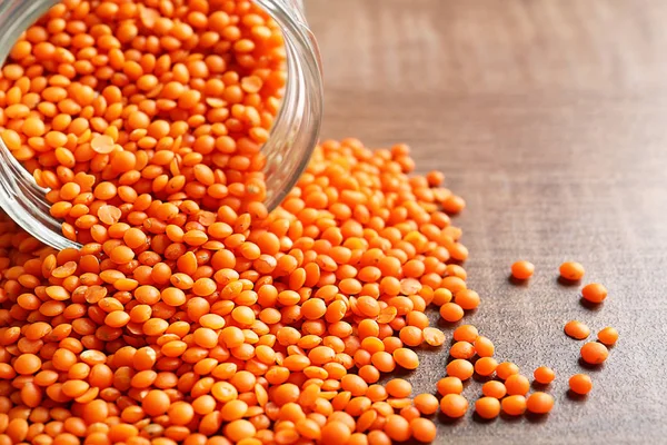 Jar of red lentils on table — Stock Photo, Image