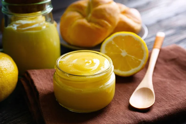 Beautiful composition with delicious lemon curd on wooden table — Stock Photo, Image