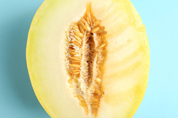 Half of juicy melon on color background. Sex concept