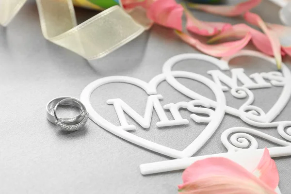 Belle composition avec anneaux pour mariage lesbien sur fond gris — Photo