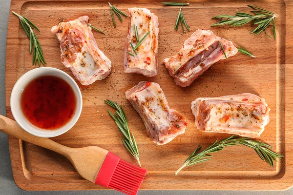 Costillas de cerdo, salsa y pincel de cocción sobre tabla de madera, primer plano —  Fotos de Stock