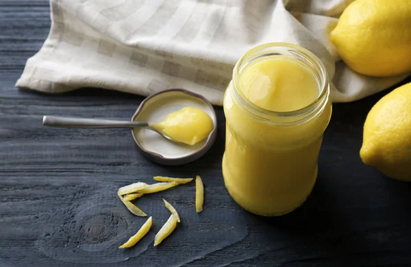 Beautiful composition with delicious lemon curd on wooden table — Stock Photo, Image