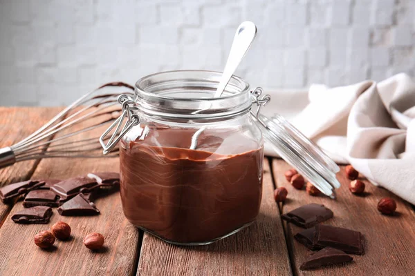 Jar with delicious chocolate sauce — Stock Photo, Image