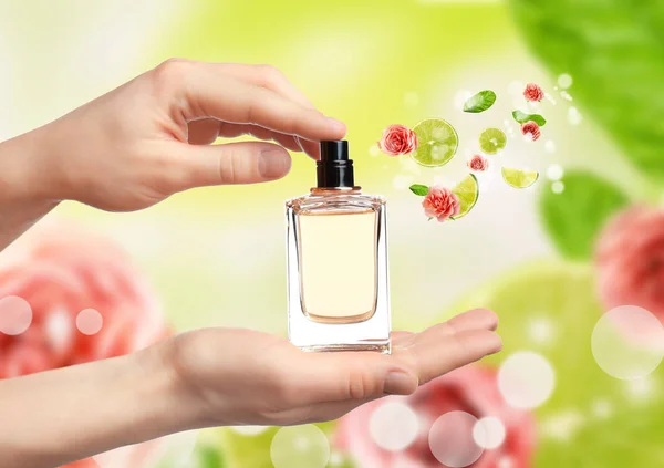 Young woman spraying perfume — Stock Photo, Image