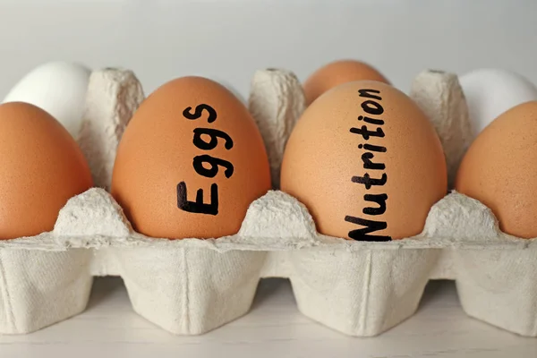 Paper holder with eggs on table. — Stock Photo, Image