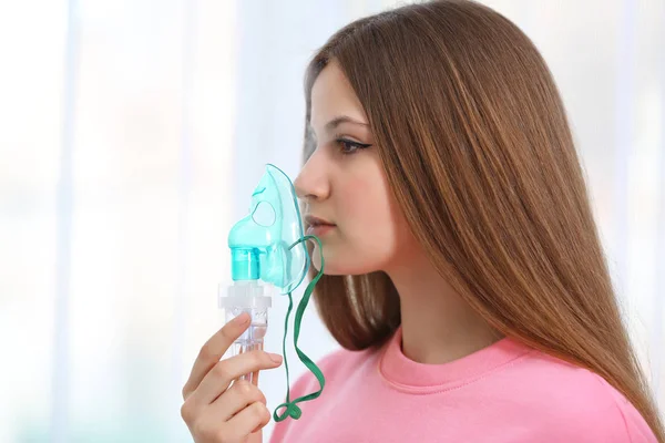 Mujer joven usando nebulizador — Foto de Stock