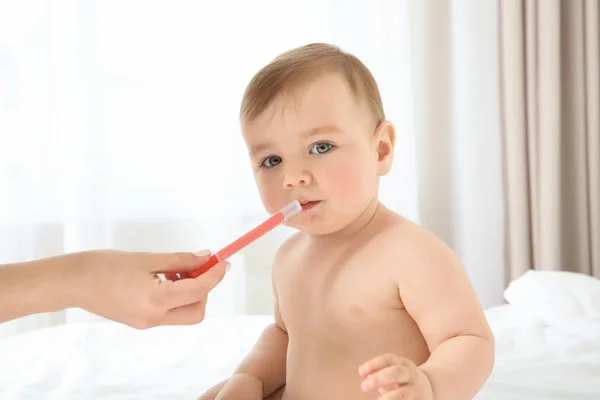 Mãe segurando seringa doseadora oral — Fotografia de Stock