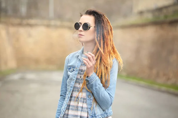 Young beautiful woman smoking weed